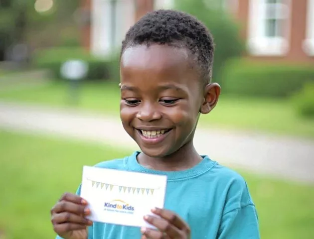 Foster child reading his a card.