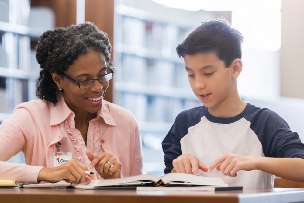 UGrad student boy holding UGrad book
